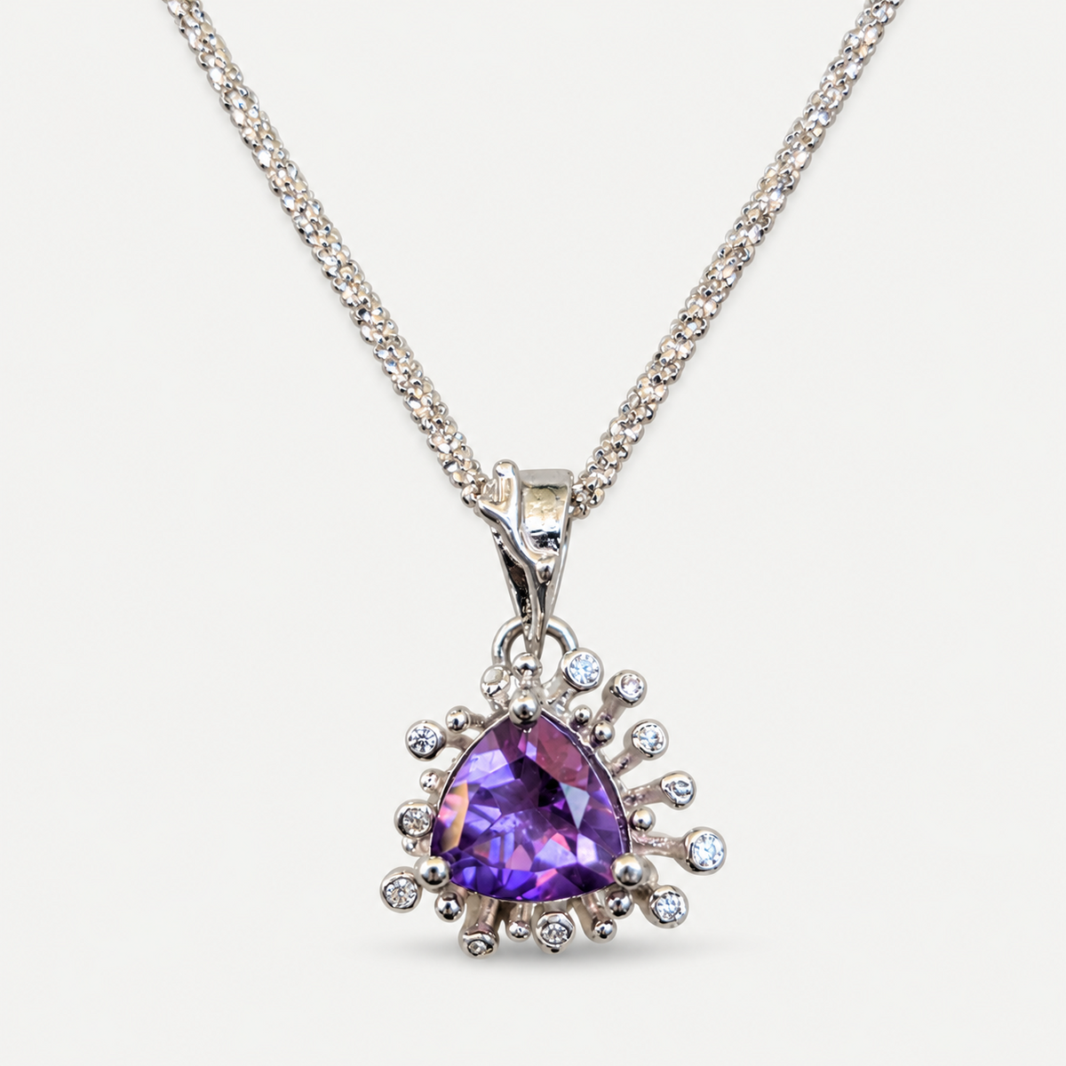 Amethyst pendant and cubic zirconia starburst close up