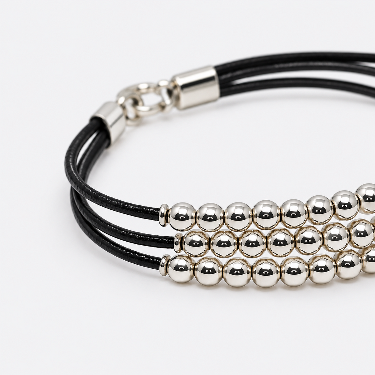 VILOS polished bead and black cord bracelet detail