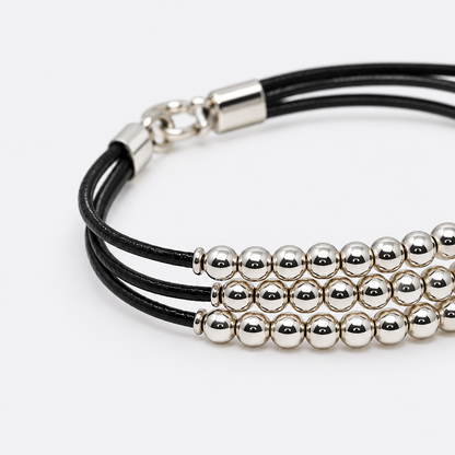 VILOS polished bead and black cord bracelet detail