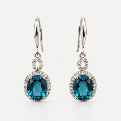 London Blue Topaz Drop Earrings in sterling silver on a neutral background