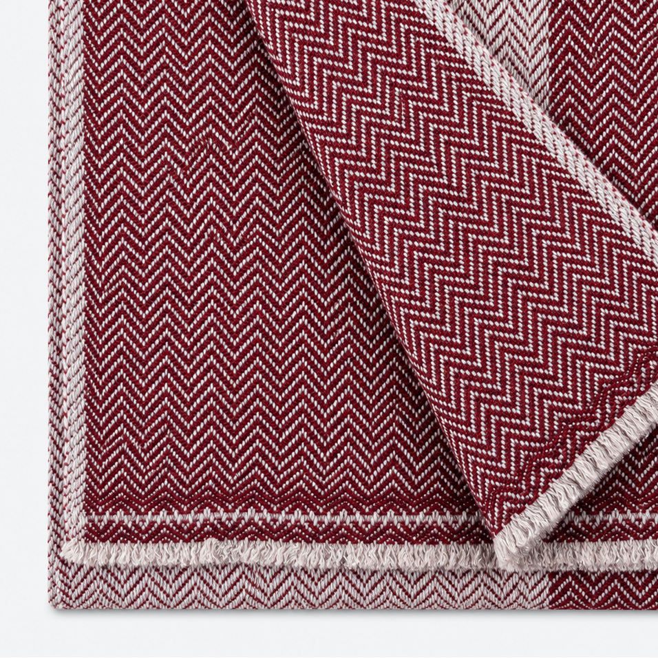 Burgundy and ivory herringbone scarf folded close-up