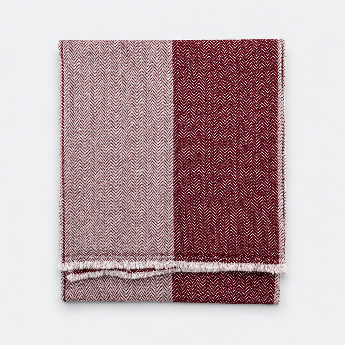 Two-tone burgundy and ivory scarf folded flat