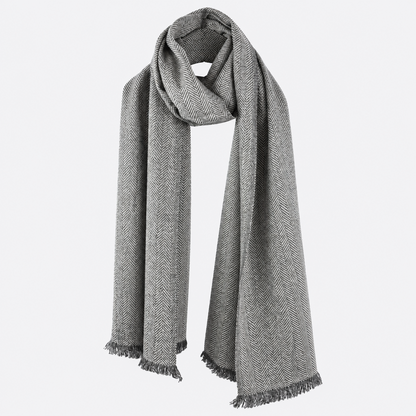 Gray herringbone scarf draped with fringed ends