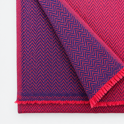 Magenta and navy herringbone woven pattern close-up