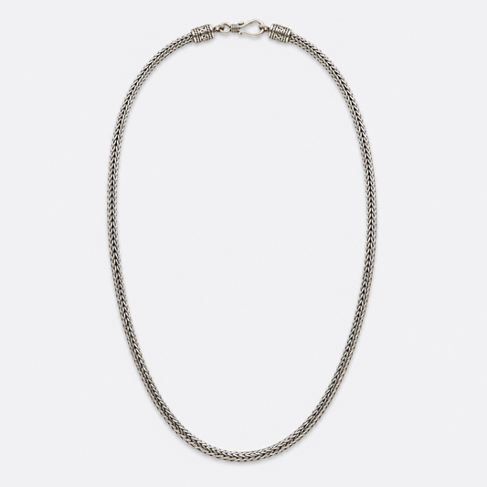 Full view of ornate woven silver chain necklace